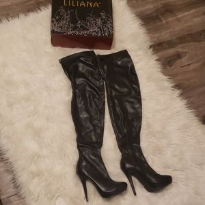 Black leather thigh high heeled boots